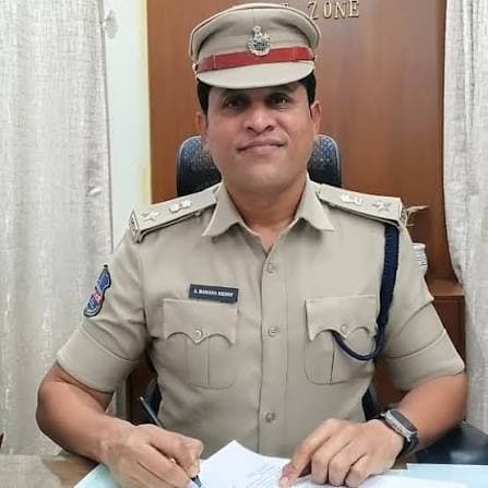 A. Ramana Reddy in police uniform at his desk
