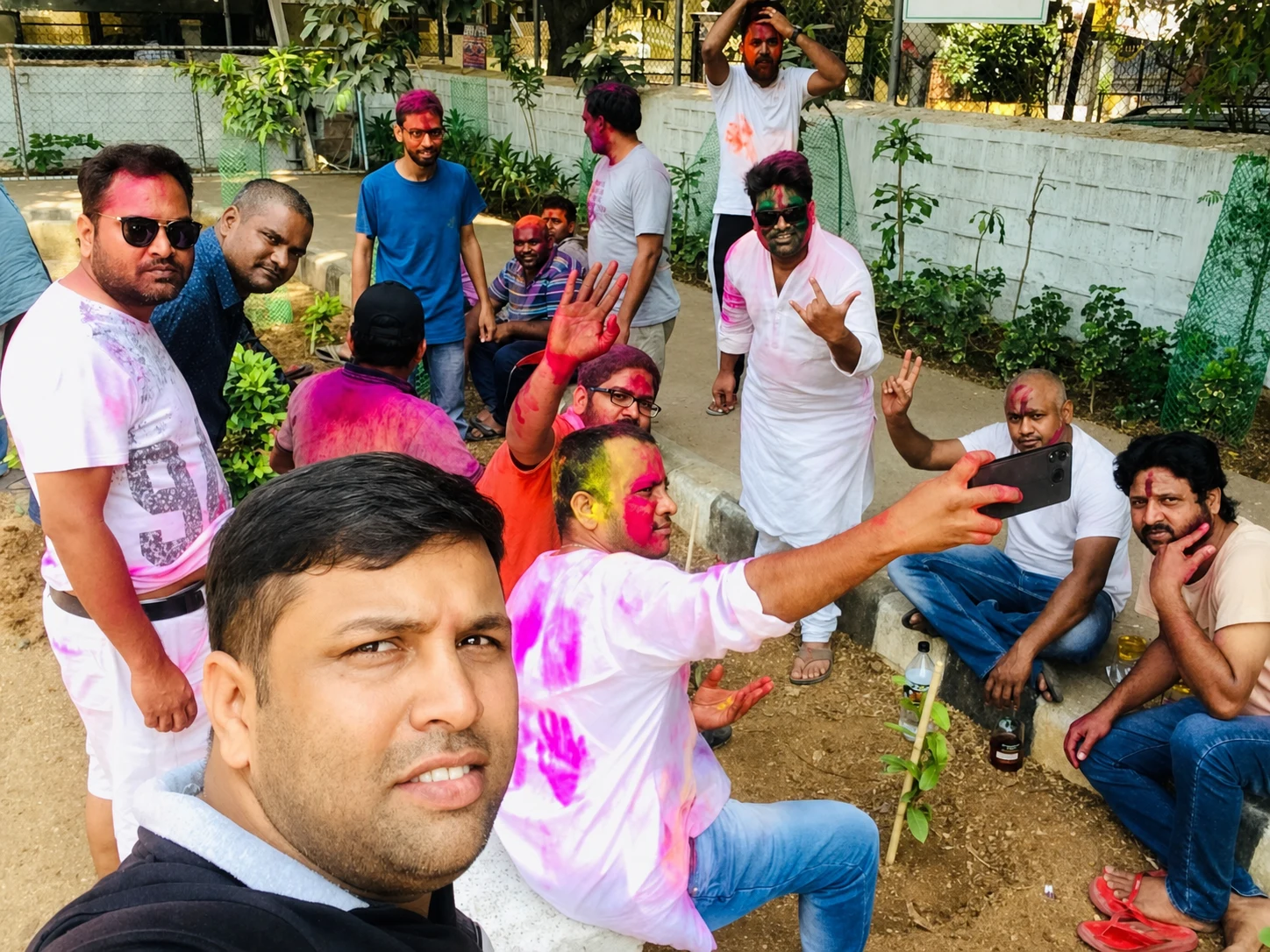 Friends resting and taking photographs together during Holi