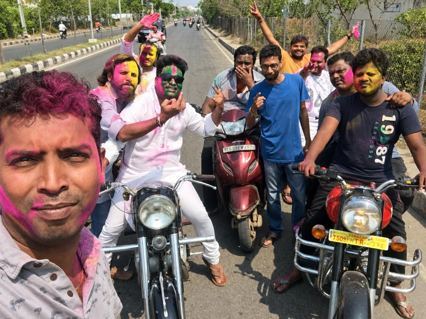 A Holi group gathered with motorcycles on a quiet road