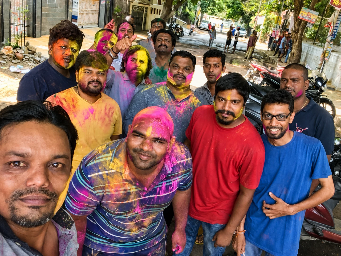 A close group selfie after playing Holi on an SR Nagar street